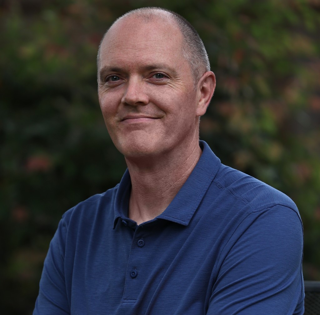 James Howard, in a blue polo shirt