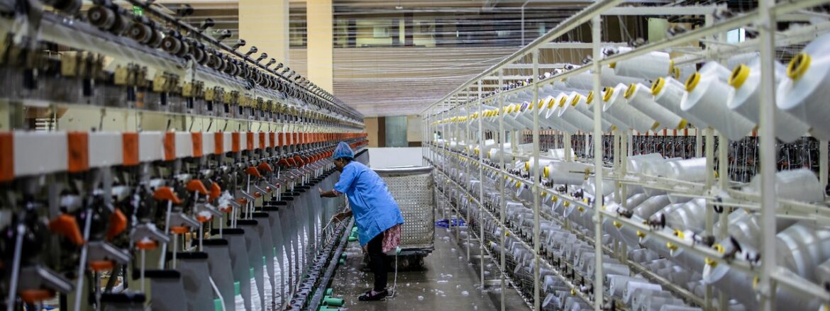 worker supervising automated sewing