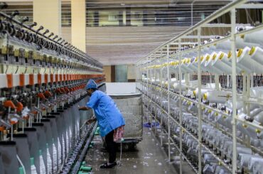 worker supervising automated sewing