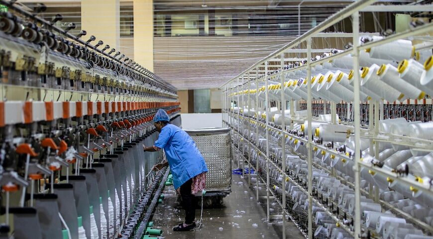 worker supervising automated sewing
